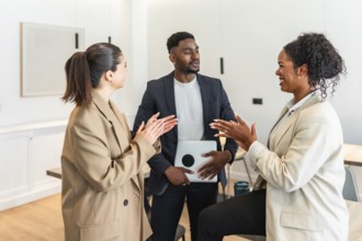 Business colleagues clapping and discussing during a productive meeting in a modern office