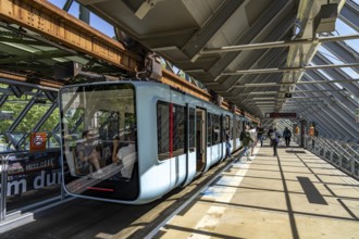 The Wuppertal suspension railway, train of the latest generation 15, floats above the Wupper,