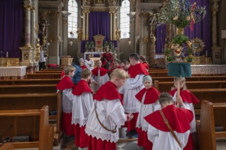 Altar servers preparing for the palm tree procession, tradition since the 18th century, Parish