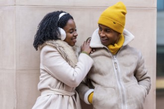 Two friends enjoying a winter day in the city, sharing a moment of complicity and affection