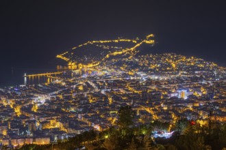 The lights of the city of Alanya on the Turkish Riviera glow in the evening, Alanya, Antalya,