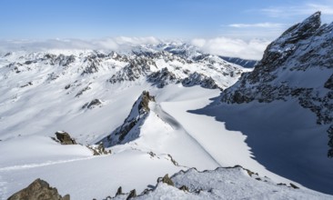 Mountain ridge of Piz Kesch, ascent on Piz Kesch or Piz d'Es-cha in winter, spectacular mountain