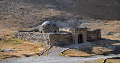 Historic caravanserai Tash Rabat from the 15th century, with yellow hills, Atbashy district in the