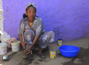 In the highlands of Abyssinia, in the village of Sina, young woman prepares coffee for the coffee