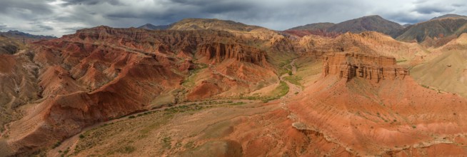 Eroded mountain landscape, canyon with red and orange rock formations, aerial view, Konorchek