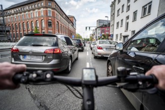 Cycling in the city, city centre road, no cycle lane, two-lane traffic in both directions,