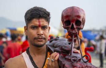 A Hindu priest arrives awith a human skull on the bank of Brahmaputra river on Ashoka Ashtami
