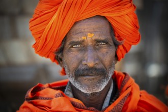 Man with orange turban and yellow bindi on his forehead, portrait, Chittorgarh Fort, Chittorgarh,