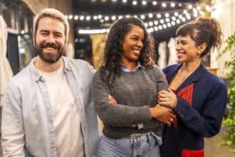 Multi-ethnic millennial friends smiling standing on night bar terrace celebrating a party