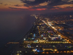 The lights of the tourist accommodations on the Turkish Riviera near Alanya glow colourfully in the