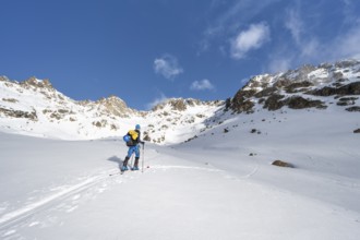 Ski tourers in a wintry mountain landscape, ascent to Porta d'Es-cha, Grisons Haute Route ski tour,