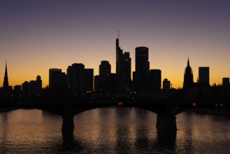 The silhouette of Frankfurt's banking skyline stands out in the evening against the residual light