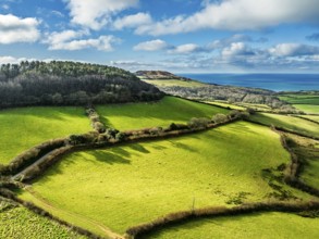 Farms over Morcombelake Village from a drone, Bridport, Dorset, England, United Kingdom, Europe