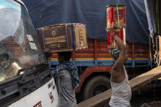 GUWAHATI, INDIA - MAY 1: Labourers carries goods in a wholesale market, in Guwahati, India, on May