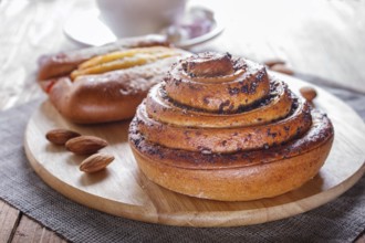A cup of hot chocolate and buns on brown wooden background. close up