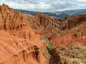 Eroded mountain landscape, canyon with red and orange rock formations, aerial view, Konorchek