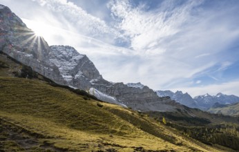 Mountain landscape with yellow meadows in autumn, summit Lamsenspitze with sun star, Karwendel,