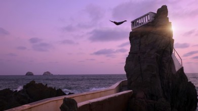 Mexico, Mazatlan El Clavadista cliff drivers diving on Malecon to entertain tourists, Central