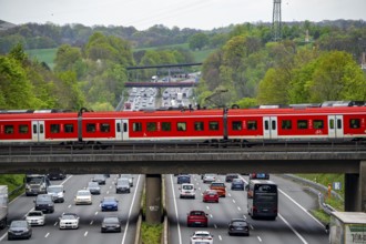 S-Bahn train crossing the motorway A3, traffic on 8 lanes, incl. the temporarily released hard