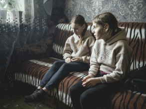Sveta and Ira in their family home in Voloska Balakliia. The village is close to the front line,