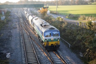Diesel locomotive freight train on the West Coast mainline at Woodborough, Wiltshire, England, UK