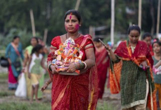 Devotees carries the Ganesha idol to immerse in the Brahmaputra river, during Ganesh Chaturthi