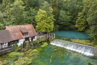 Blautopf Blaubeuren with industrial monument Hammerschmiede, source of the little river Blau in a