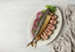 Smoked mackerel, top view, with spices, on a wooden table, no people, selective focus