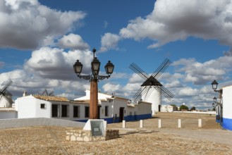 Street lamp and windmill in a picturesque village with white houses and cobbled streets, windmills