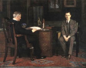 Two men are in an office, one sitting at a desk and the other on a chair, engrossed in a
