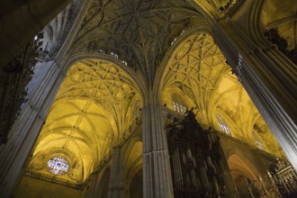 Architectural details on ceiling and stained glass rose window in Interior of The Cathedral of