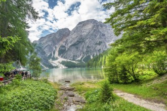 Tourists enjoying the landscape at lake braies, also called pragser wildsee, with the seekofel