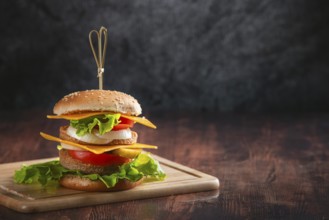 A burger on a wooden board in a rustic ambience