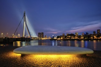 Erasmus Bridge (Erasmusbrug) and Rotterdam skyline illuminated at night. Rotterdam, Netherlands