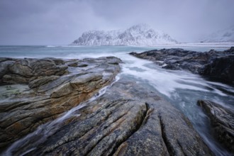 Waves and rocks on coast of Norwegian sea in fjord. Skagsanden beach, Flakstad, Lofoten islands,