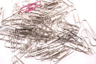 Detail of paper clips on a white background, copy and paste space