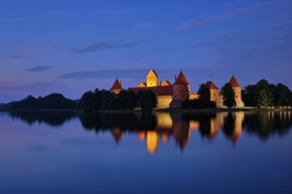 Evening view of Trakai Island Castle in lake Galve illuminated in the night, Lithuania, Europe