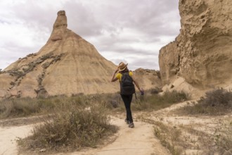 Woman with backpack walking along an arid national park
