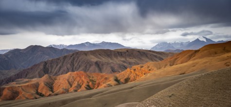 View over eroded mountainous landscape of Konorchek Canyon with red sandstone cliffs, high