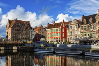 Ghent canal Graslei and Hooiaard streets with tourist boats on sunset. Ghent, Belgium, Europe