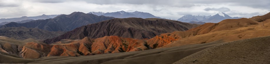 Panorama, view over eroded mountainous landscape of Konorchek Canyon with red sandstone cliffs,