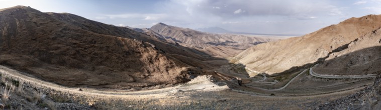 Panorama, view of mountain landscape and pass road at Tyibel Pass, Song Kul Too mountain range,