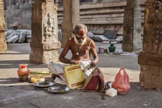 MADURAI, INDIA, FEBRUARY 16, 2013: Indian brahmin (traditional Hindu society) priest with donation