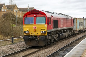 DB Cargo Class 66 freight train passing through Peterborough railway station, Cambridgeshire,
