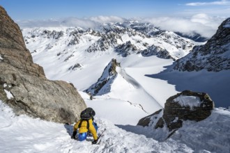 Mountaineer with ice axe and crampons, ascent through steep snowfield to Piz Kesch or Piz d'Es-cha