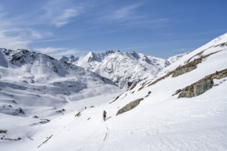 Ski tourer in mountain landscape with snow, ascent to Grialetsch Scharte, Bündner Haute Route,