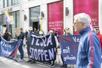 Berlin, Germany - 5 April 2025: People demonstrate in front of a Tesla shop in Berlin against Tesla