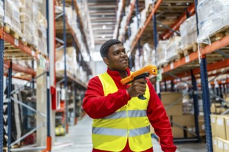 Latin male warehouse worker using bar code scanner to analyze newly arrived goods for further