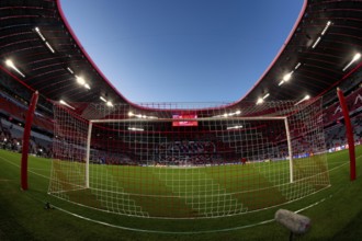 Overview, interior, floodlit match, behind-the-goal perspective, goal net, blue hour, fisheye shot,