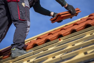 Roofer covering a tiled roof